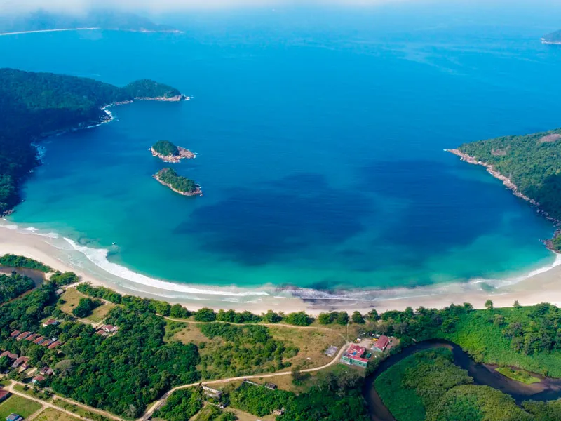Aerial of Dois Rios bay, Ilha Grande, a horseshoe beach where a river meets the sea
