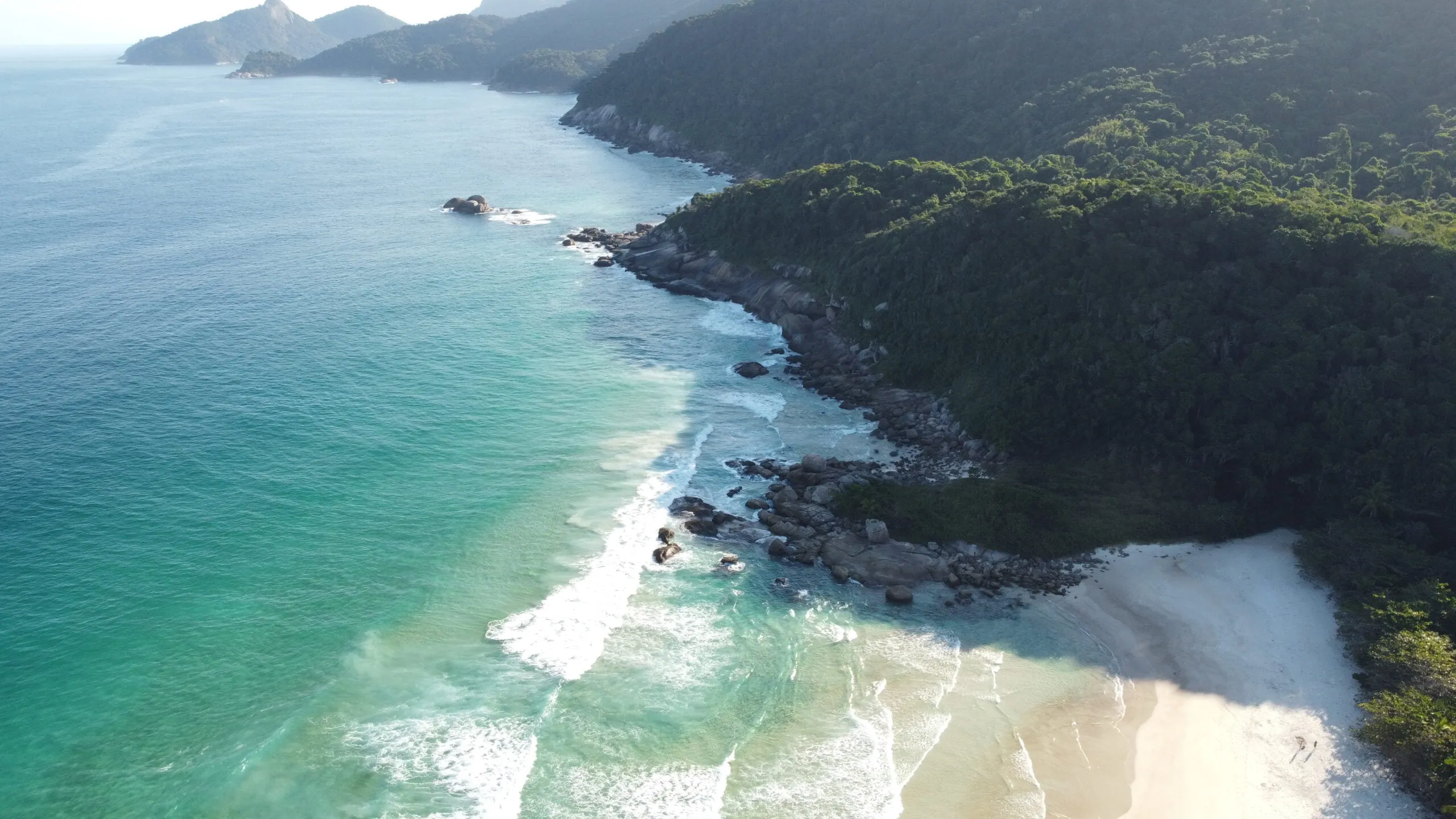 Aerial of Lopes Mendes beach with turquoise surf, the reward at the end of the trail, Ilha Grande