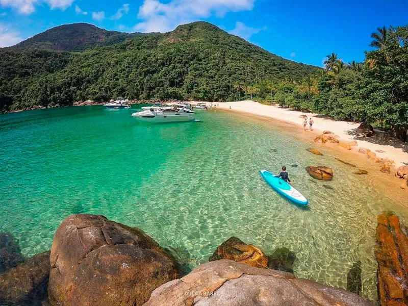 The calm turquoise cove of Praia do Meros, Ilha Grande, with anchored boats